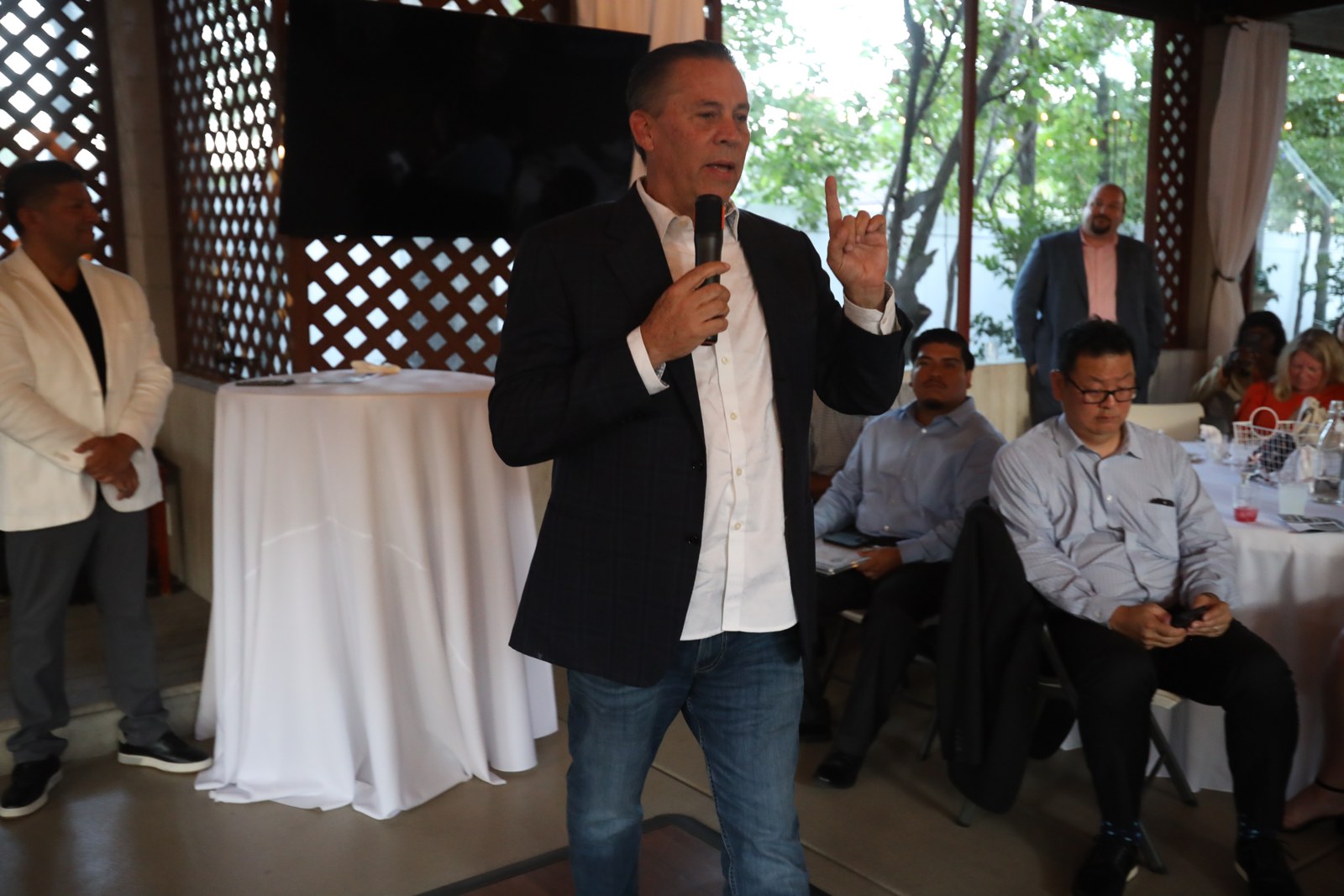 A business leader speaks to reception attendees
